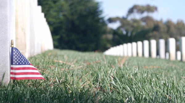 Tombstone and american flag, national military membership cemetery in USA. — стокове фото