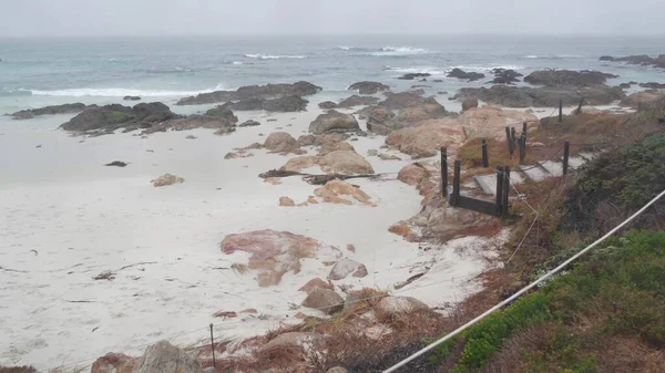 Okyanus kumlu kum tepeleri, Kaliforniya 'nın sisli kıyıları. Sisli yağmurlu hava, soğuk deniz.