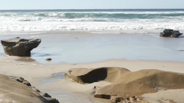 Nagy óceán hullám összeomlik a tengerparton, Kalifornia partjainál, erodált kő vagy szikla a homokban — Stock videók