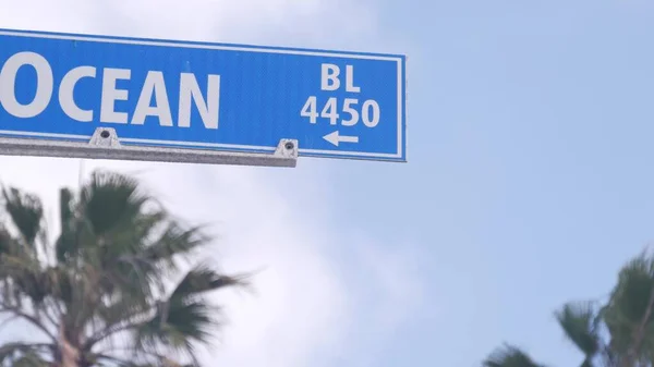 Ocean street road sign, California city USA. Tourist resort, coastal palm trees — Stock Photo, Image