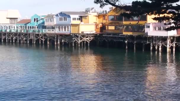 Colorful wooden houses on piles or pillars, Old Fishermans Wharf, Monterey bay. — Stock Video