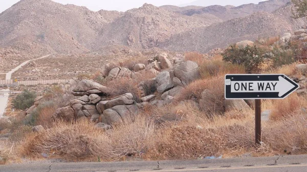 One way road sign arrow, highway roadside in California, USA road trip in desert