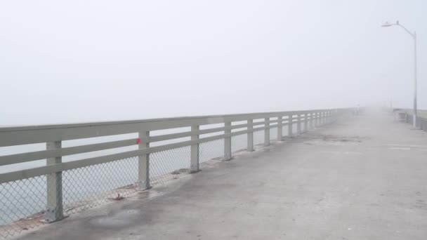 Wooden Ocean Beach pier in fog, misty calm boardwalk in haze, California coast. — Stock Video