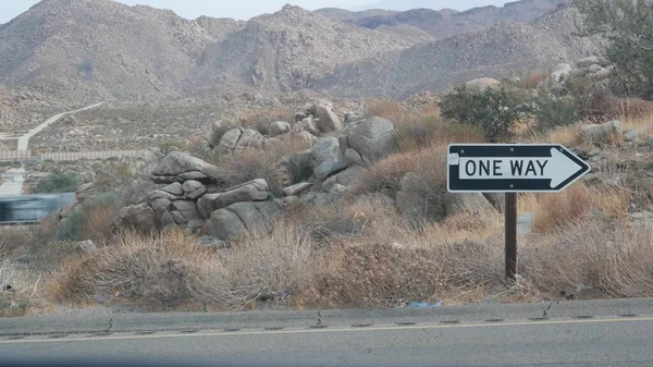 One way road sign arrow, highway roadside in California, USA road trip in desert