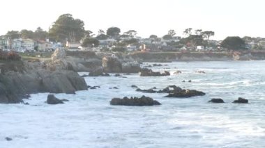 Rocky sarkık okyanus plajı, kıyıya vuran deniz dalgaları, Monterey 17 mil sürüş, California sahili, ABD. Pasifik Korusu, sahil kıyısı gezinti alanı, deniz kenarındaki tarihi evler, sömürge mimarisi..