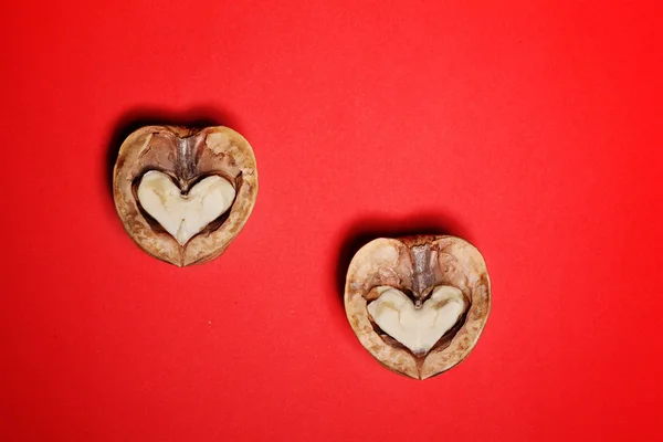 Nut has broken in half, the two halves of the heart on background, a card for Valentines Day — Stock Photo, Image