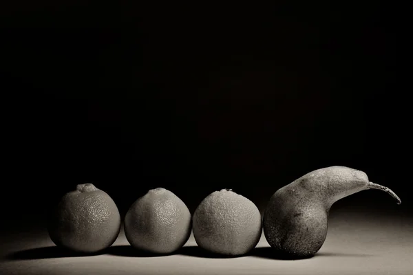 Tragiska historien om frukt, päron och tangeriner på svart bakgrund — Stockfoto