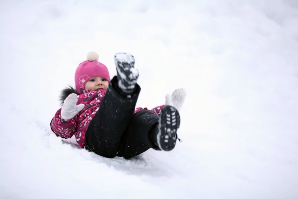 Happy little girl riding on icy hill — Stock Photo, Image