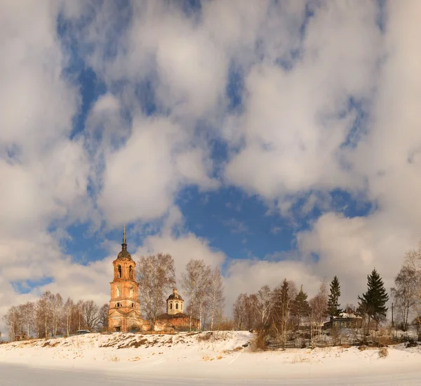 Orthodox church on the bank of the frozen river Royalty Free Stock Photos