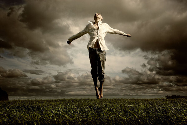 Man flying over a green meadow