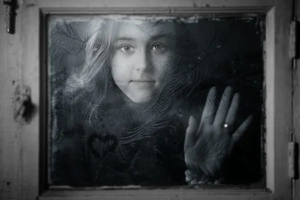 Portrait of a girl outside the window — Stock Photo, Image