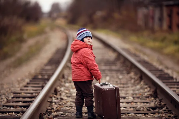 Little traveler with a suitcase on the railroad — Stock Photo, Image