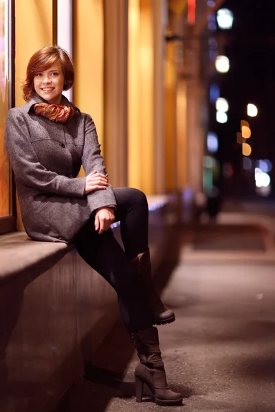 Menina sorridente alegre em uma cidade da noite do outono — Fotografia de Stock