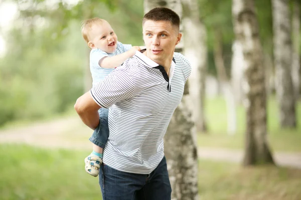 Little boy playing in the park with dad Stock Image