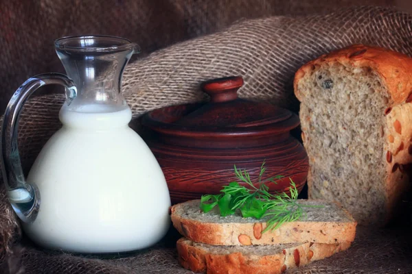 Jug with milk and bread — Stock Photo, Image