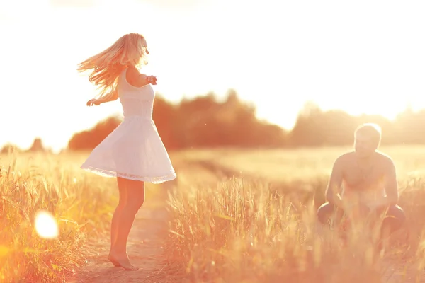 Lovers in wheat field — Stock Photo, Image