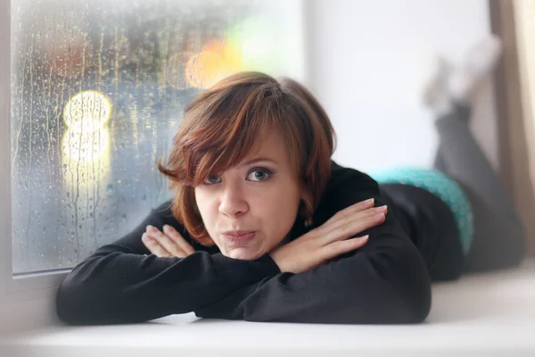 Girl on the windowsill — Stock Photo, Image