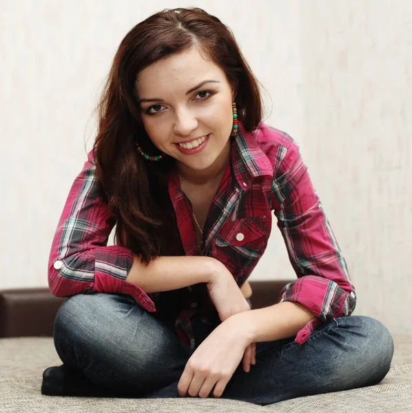 Brunette sits on floor Stock Picture