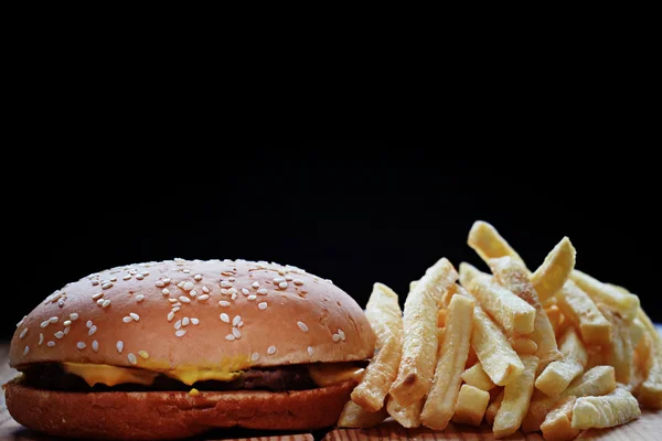 Cheeseburger and fries — Stock Photo, Image