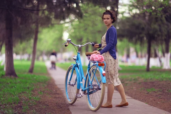 Ragazza con bicicletta nel parco — Foto Stock