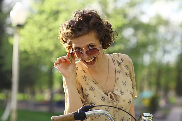 Menina sorridente com bicicleta — Fotografia de Stock