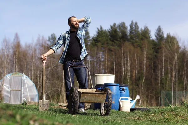 Man with wheelbarrow Stock Photo