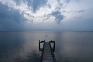 Pier on Mobile Bay at Daphne, Alabama Bayfront park during an evening April storm