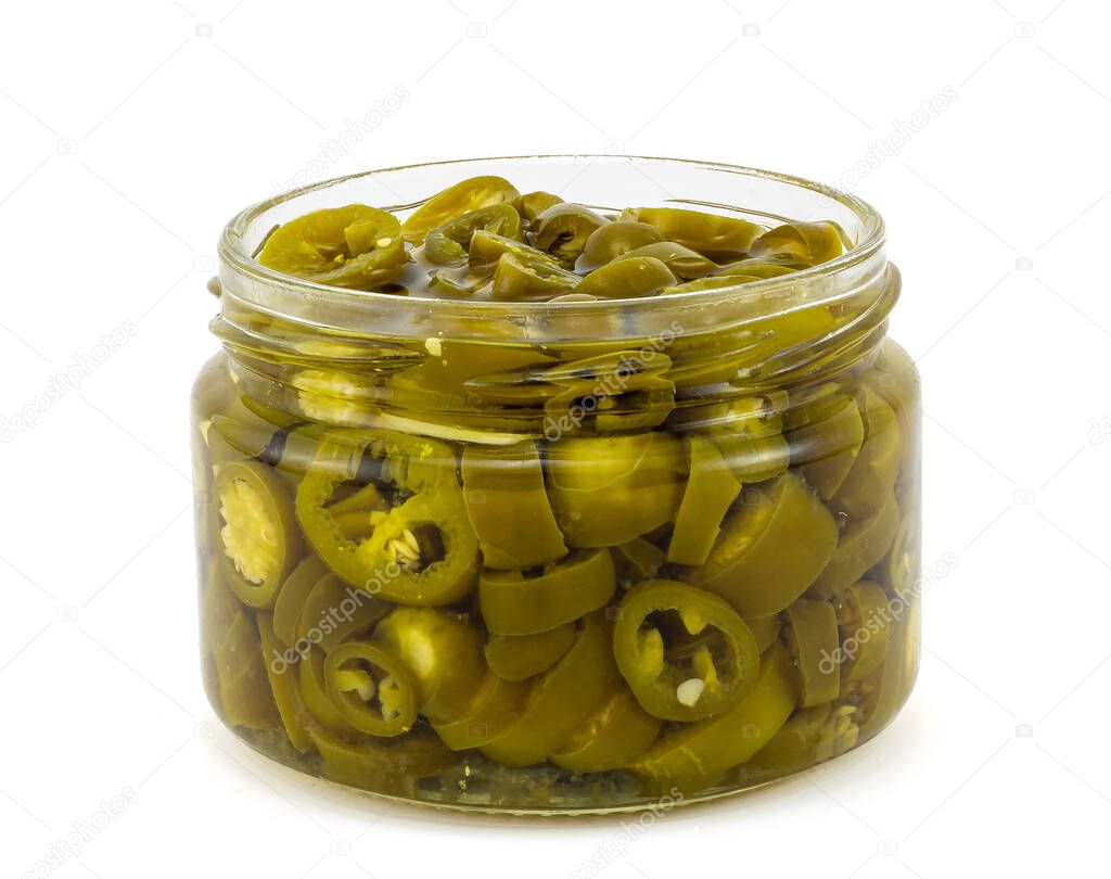 Sliced of pickled jalapeno peppers in a glass jar isolated on white background. Side view