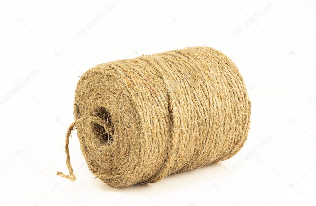 Roll of hemp twine cord isolated on white background. Skein of natural jute twine.