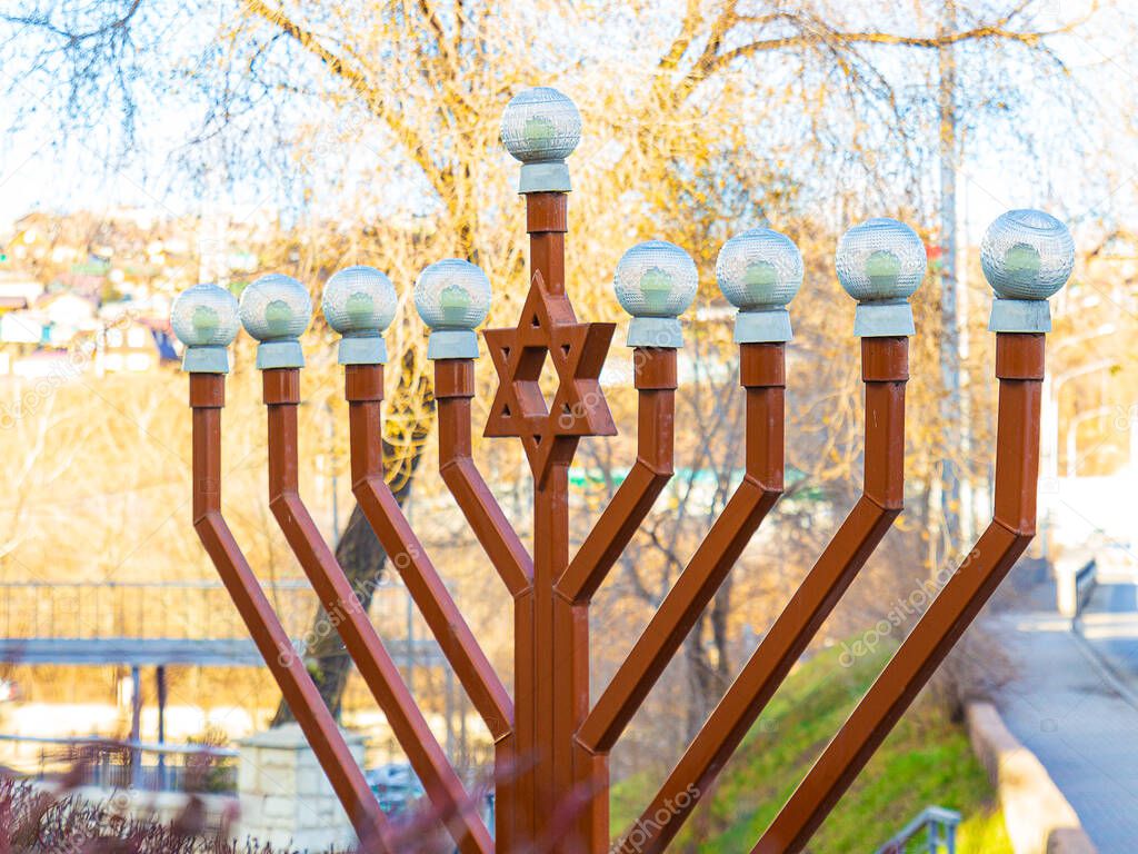 Close-up of Hanukkah shaped street lamp next to the synagogue in Krasnoyarsk, Russia. Hanukkiah is a nine-branched candelabrum lit during the eight-day Jewish holiday of Hanukkah.