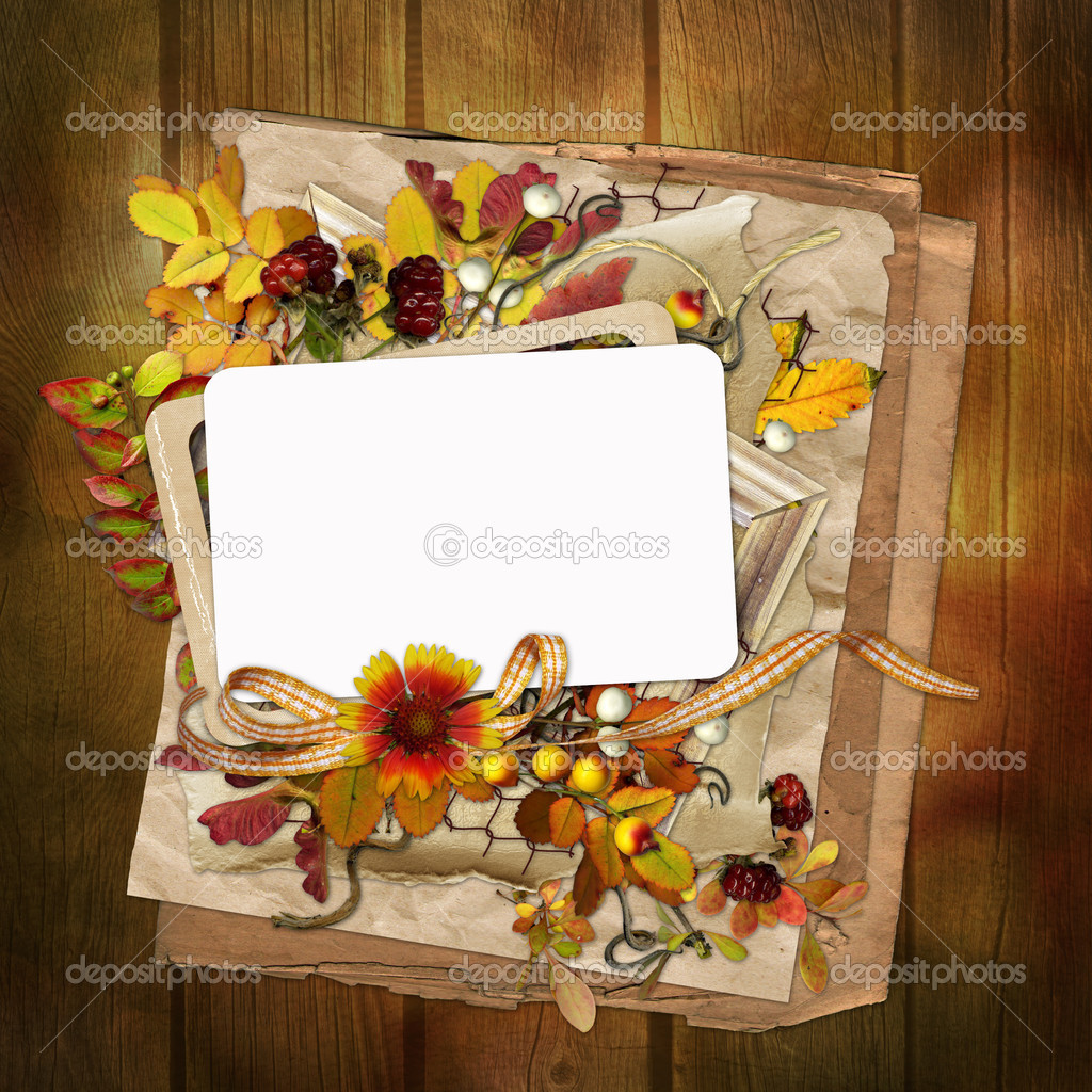 Frame with autumn leaves and berries on wooden background