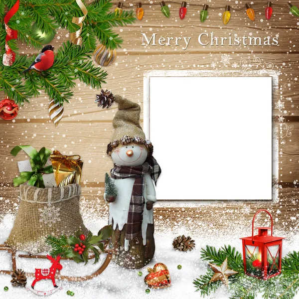 Christmas decoration with snowman, gift bag and a card on a wooden background — Stock Photo, Image