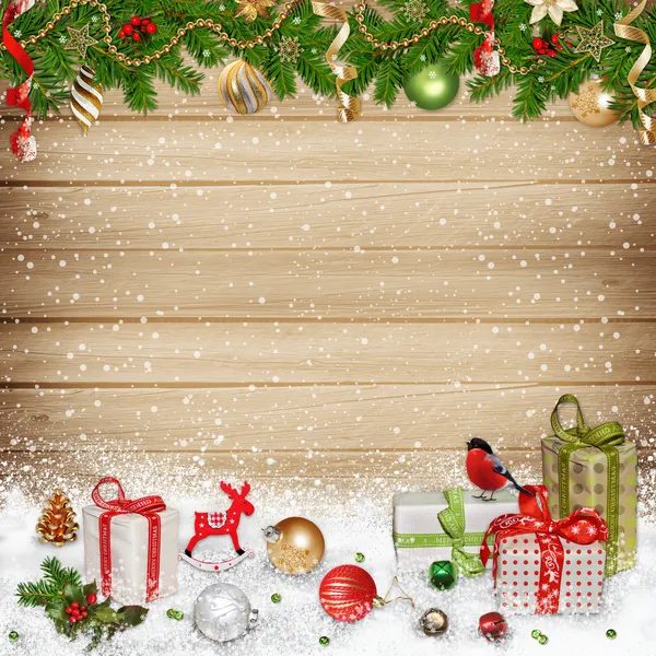 Christmas decorations and gifts on a wooden background — Stock Photo, Image