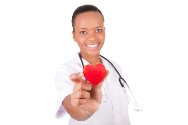 Young nurse with heart in her hand — Stock Photo, Image