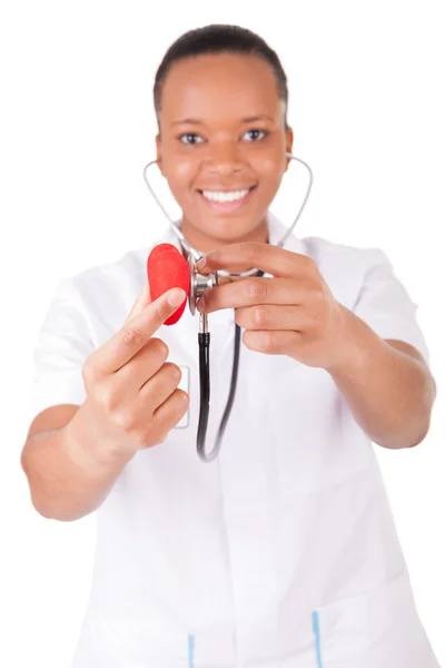 Young nurse with heart in her hand — Stock Photo, Image