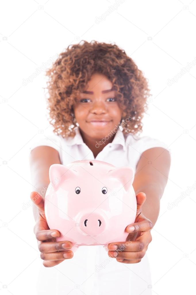 Happy Young Woman Saves Money in Piggy bank