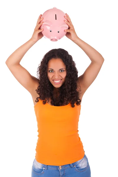 Young african american woman putting coin in piggy bank — Stock Photo, Image