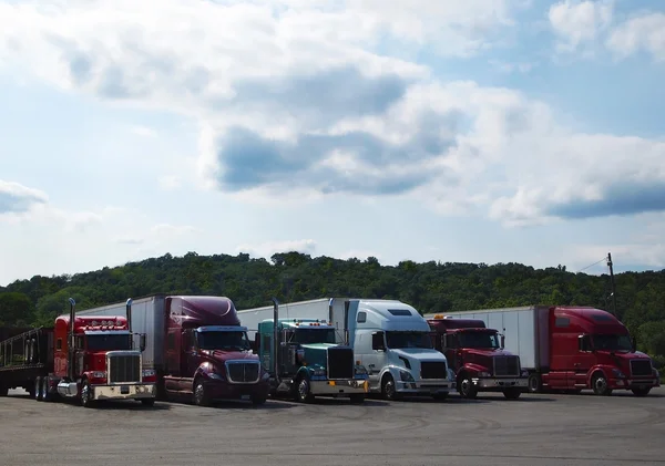 Row of Parked Trucks at Truck Stop Stock Picture