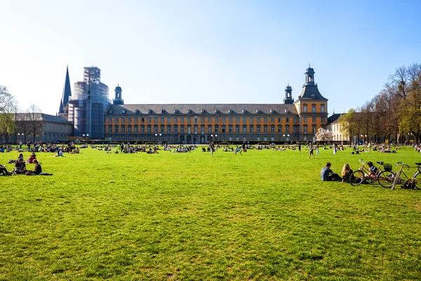 La gente si gode una giornata di sole nel parco Hofgarten a Bonn — Foto Stock