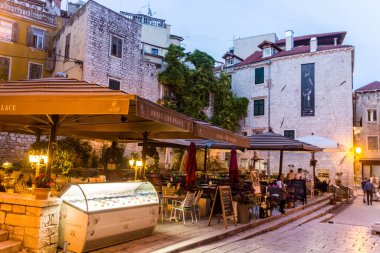 SIBENIK, CROATIA - MAY 25, 2019: Evening view of open air restaurants at Trg Palih sibenskih boraca square in Sibenik, Croatia