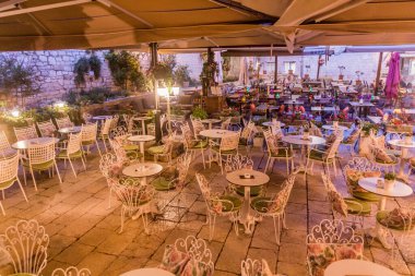 SIBENIK, CROATIA - MAY 25, 2019: Evening view of open air restaurants at Trg Palih sibenskih boraca square in Sibenik, Croatia