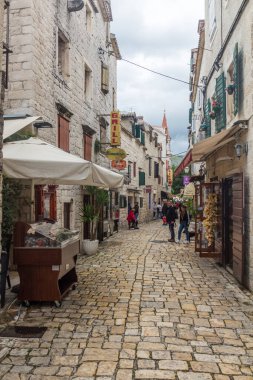 TROGIR, CROATIA - MAY 27, 2019: Narrow alley in the old town of Trogir, Croatia