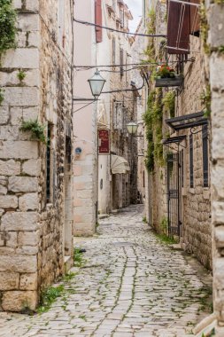 TROGIR, CROATIA - MAY 27, 2019: Narrow alley in the old town of Trogir, Croatia