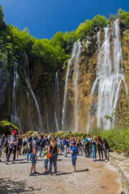 PLITVICE, CROATIA - MAY 24, 2019: Tourists visit Veliki Slap waterfall Plitvice Lakes National Park, Croatia