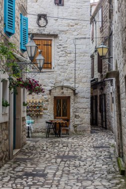 TROGIR, CROATIA - MAY 27, 2019: Narrow alley in the old town of Trogir, Croatia