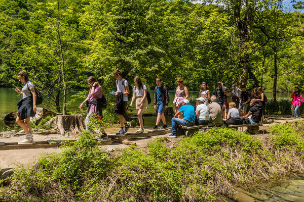 PLITVICE, CROATIA - MAY 24, 2019: Tourists visit Plitvice Lakes National Park, Croatia