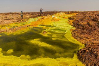 DANAKİL, ETHIOPIA - 24 Mart 2019: Turistler Dallol volkanik alanının renkli sülfürik göllerinin, Danakil depresyonunun ve Etiyopya 'nın fotoğraflarını çekiyorlar