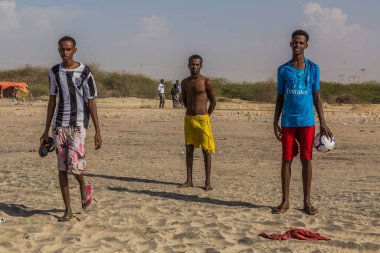 BERBERA, SOMALILAND - APRIL 13, 2019: Young men on a beach near Berbera, Somaliland
