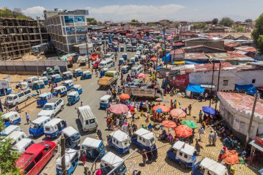 HARAR, ETHIOPIA - APRIL 8, 2019: Aerial view of road traffic with tuk tuks (bajaj) and a market in Harar, Ethiopia