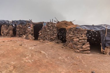 Stone huts at Erta Ale volcano crater rim in Afar depression, Ethiopia